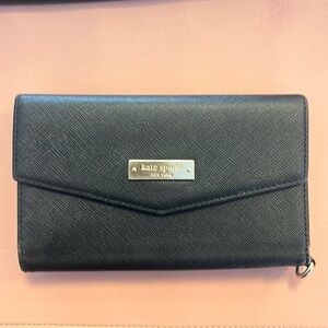 Black kate spade wallet does have a small tear on the inside.